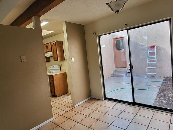 Kitchen on the left, dining room with glass doors to the patio on the right