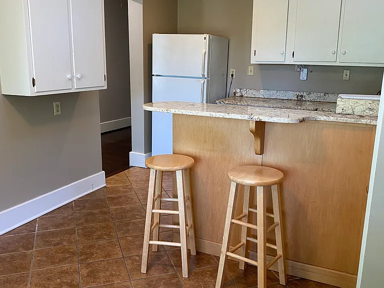 kitchen has ceramic flooring and marble counters