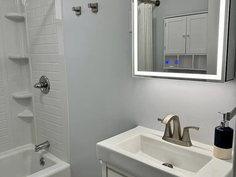 Bathroom with mirror with light