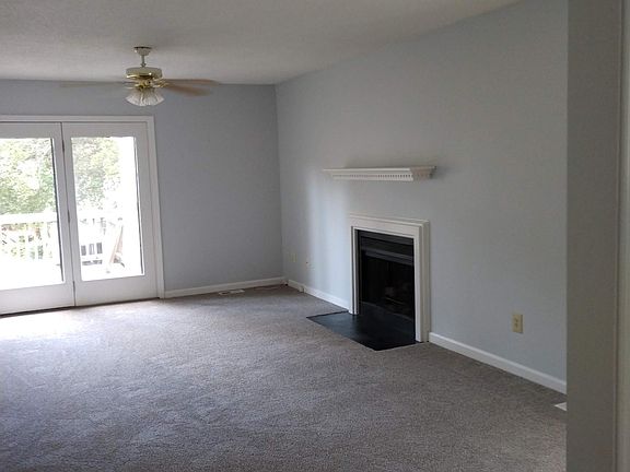 living rooms with fireplace and doors to elevated deck