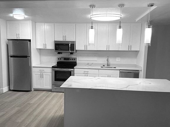 Modern White Kitchen With A Quartz Countertop
