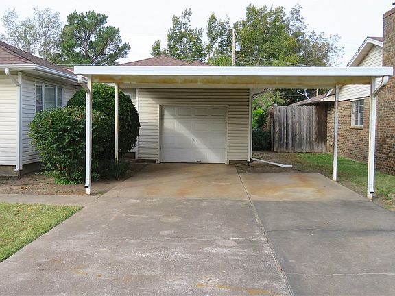 1 car garbage with 2 car car port.