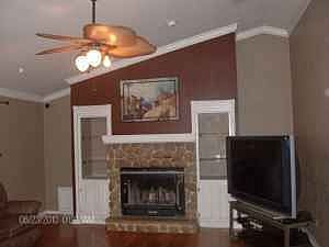living room with wood burning fireplace