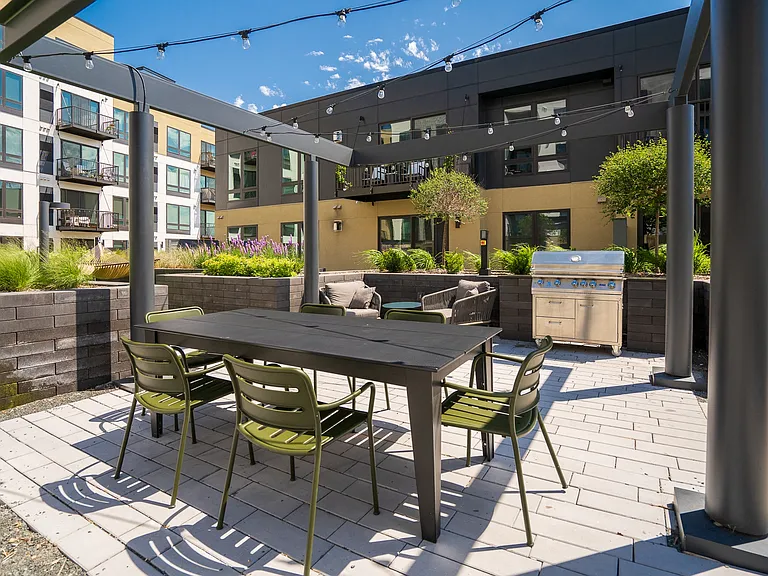 Host memorable gatherings with friends in a stylish outdoor dining and grilling area.