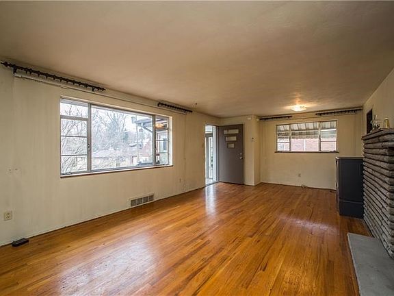 Living room showing additional window that overlooks drive to attached garage.