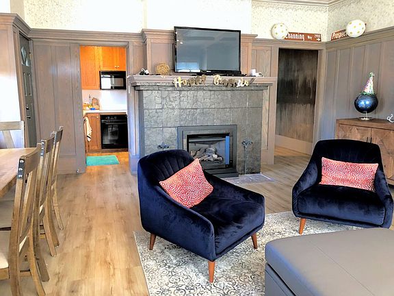 Cozy LR w/ Gas Fireplace Heater, Dining/ Study Table for 5pp to the left and the Kitchen beyond.