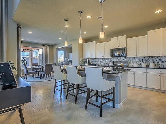 Open kitchen with breakfast bar seating at the island.