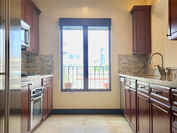 Kitchen with granite countertops and stainless appliances 