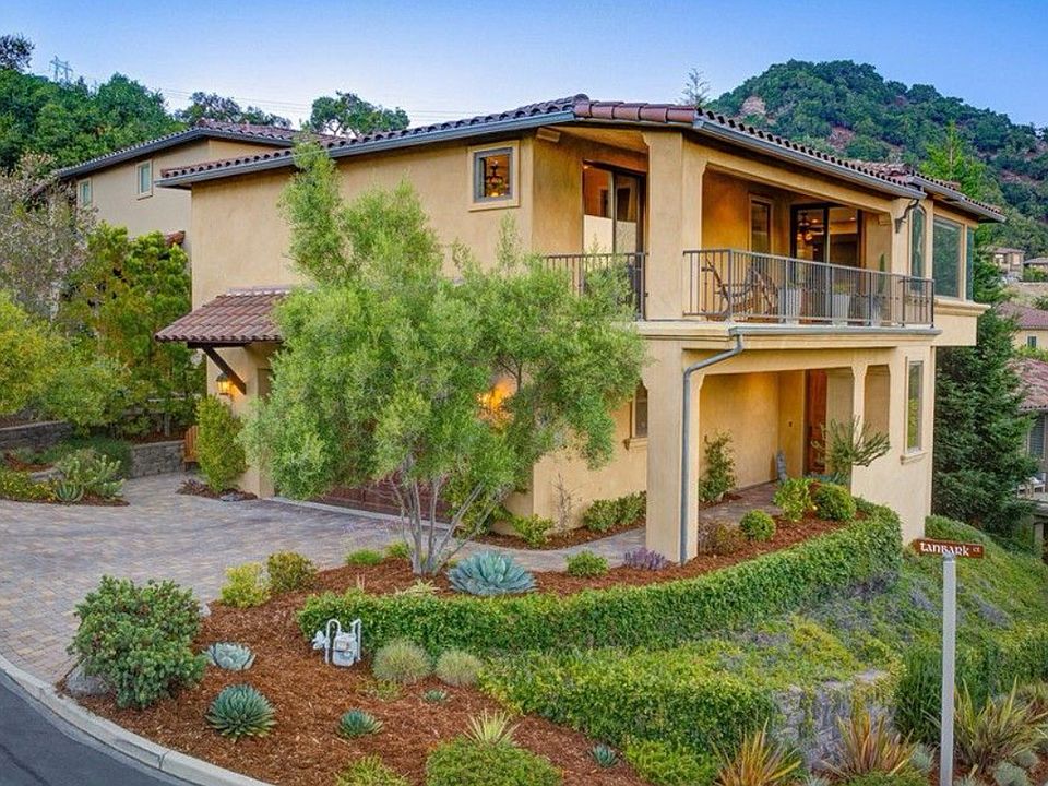 Front exterior showcasing Mediterranean architecture and hillside setting