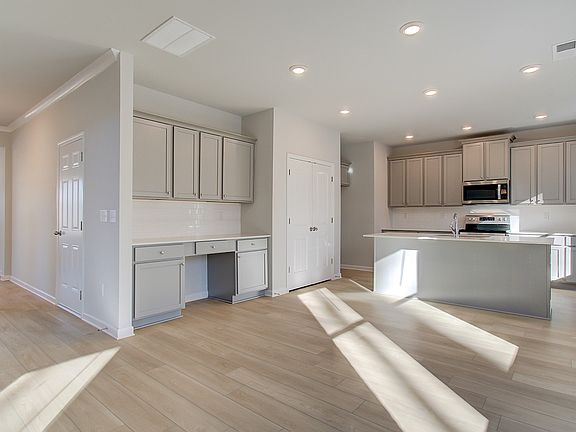 Expansive Pelham kitchen with abundant cabinetry, center island, and neutral modern finishes at Bowe