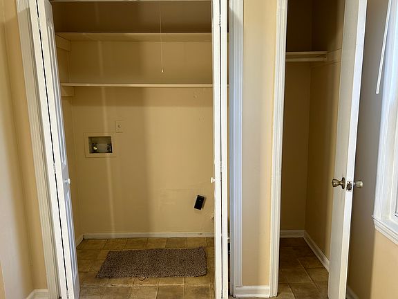 laundry room with shelves and coat closet/linen closet/storage area