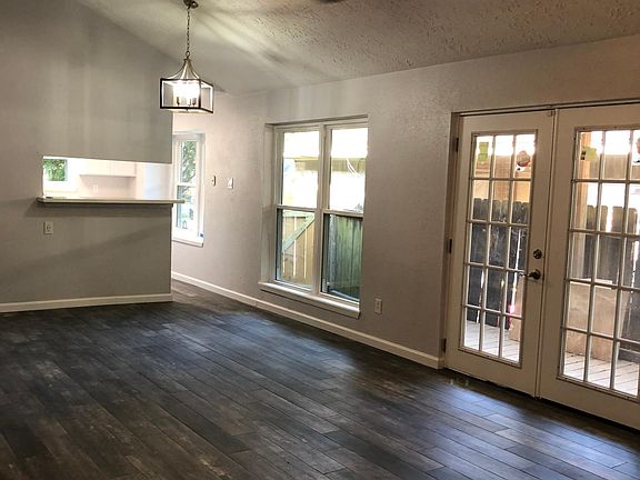 Open Living and Dining Area with new LED fixtures and French Patio Doors. Beautiful porcelain distressed wood plank flooring.