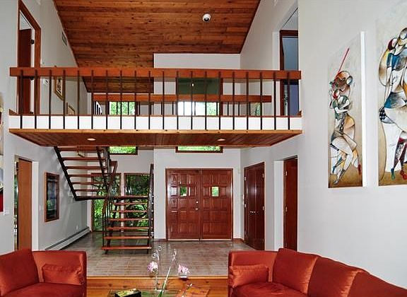 View of entry and upstairs landing from step down living room
