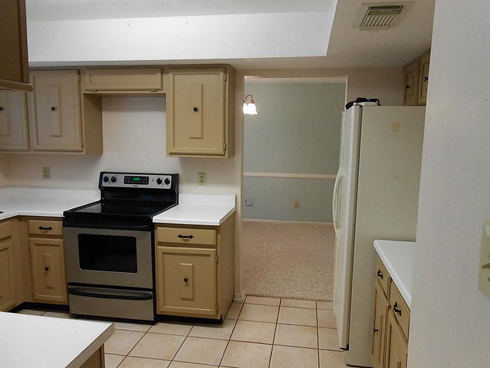 Full view of kitchen, black oven/store, and dishwasher.  Fridge  can stay.
