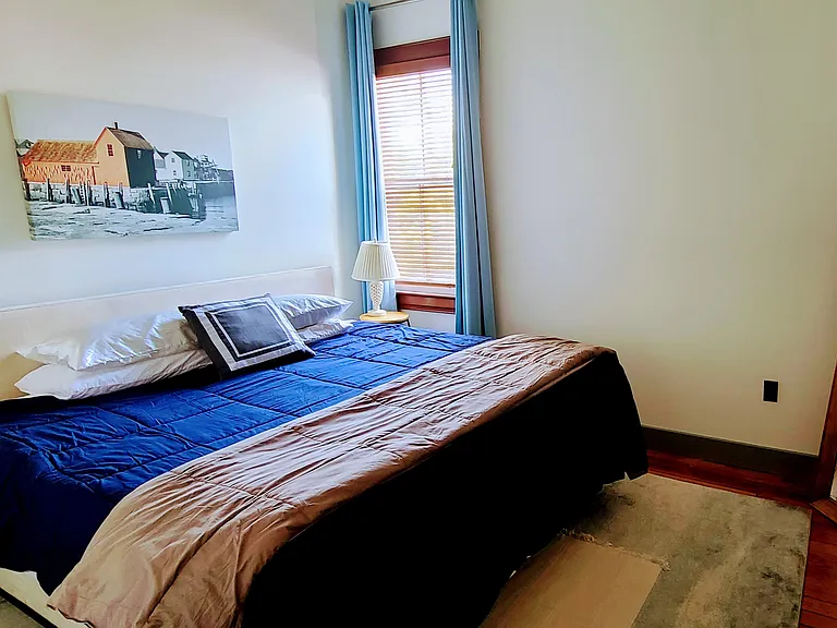 King size bed. New lamps and side tables just added (updated picture forthcoming). Adjustable wooden blinds and curtain.