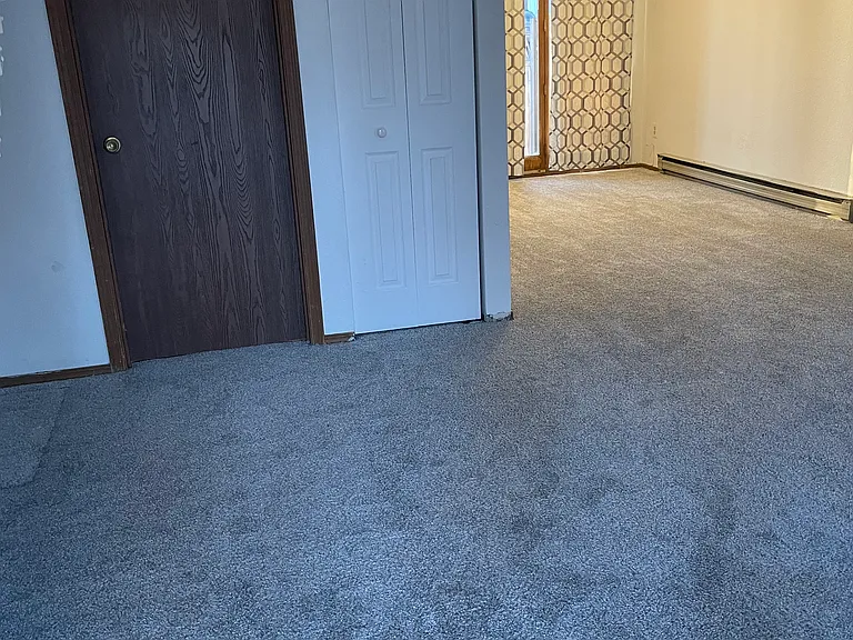 Entryway view, 1/2 bath, coat closet and view of dining area to the French Doors.