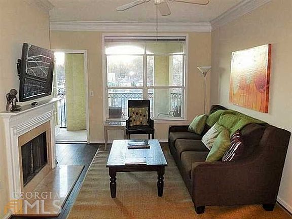 Living room opens to the balcony and has a working fireplace