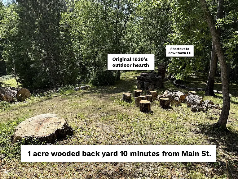 Behind the shared driveway is a stone wall and steps that lead to an acre of wooded, secluded peace and quiet. The front portion is cleared and has an original outdoor hearth for a fire. Set up some chairs, listen to the birds and relax in privacy.