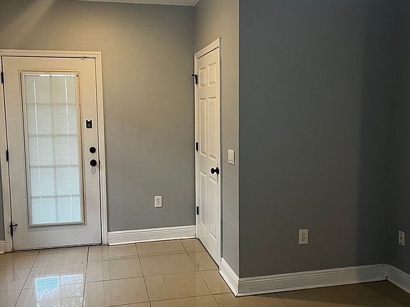 Looking back at front door and half bath