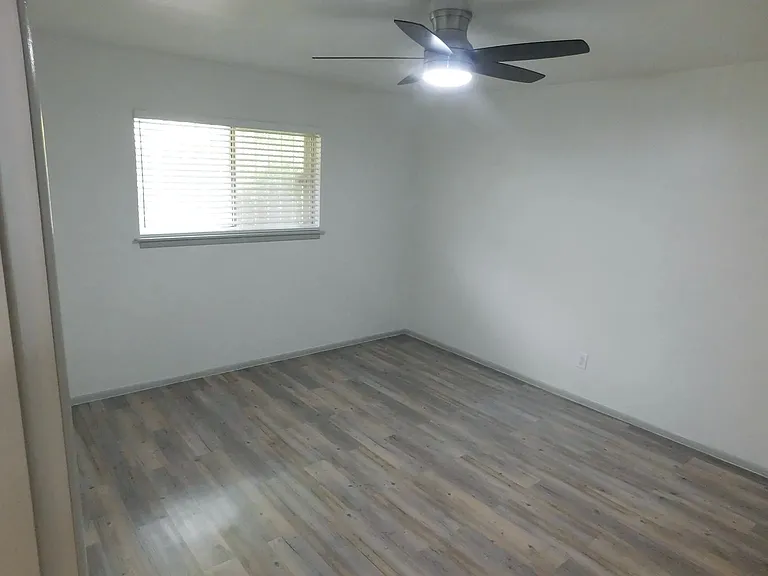 Second bedroom with one-half bath with stack washer and dryer, and walk-in closet.