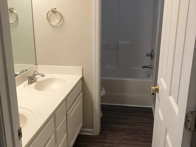Bath with pocket door shared by bedroom 2 and 3