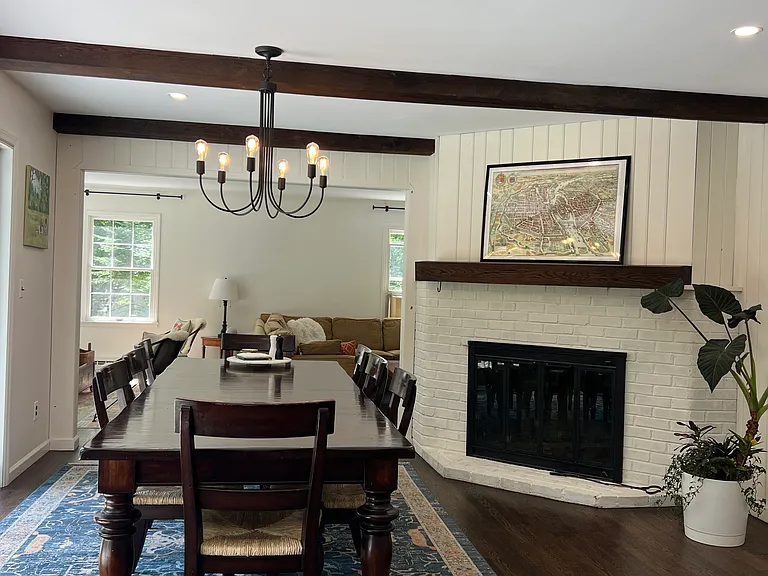 Wood burning fireplace adjacent to dining room table.