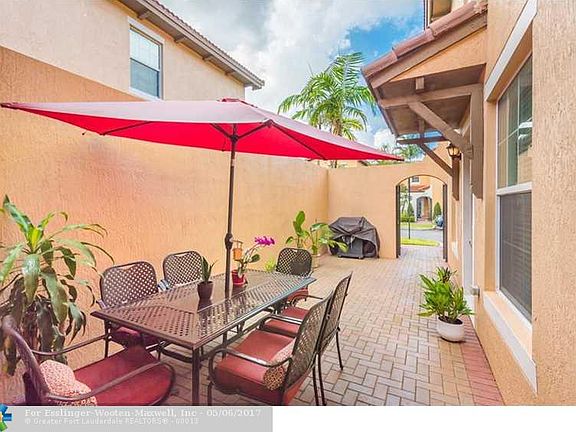 Impressive Mediterranean Inspired Town Home In Highly Desired West Pembroke Pines Gated Community.