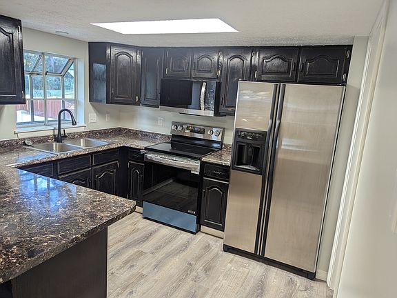 Kitchen with new faucet, deep well sink, LG Microwave & Stove. Stainless Kenmore Refrigerator with water and ice dispenser