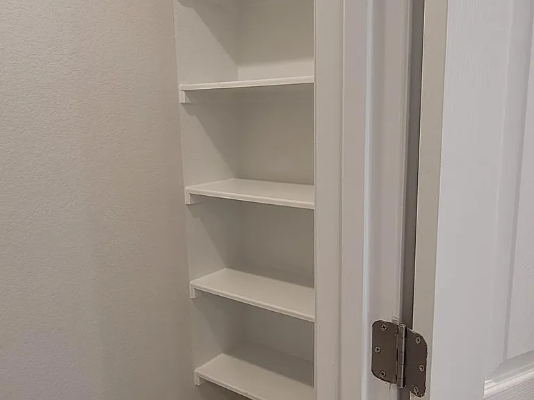 linen shelves in primary bath