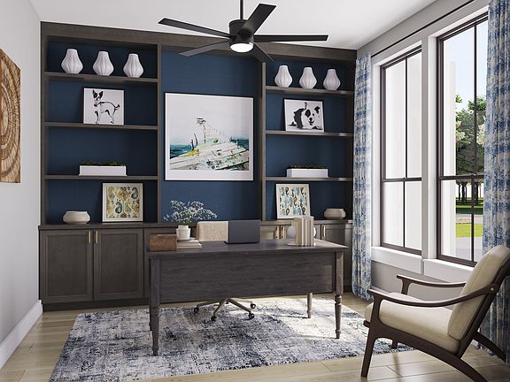 A cozy and well-designed home office space with a dark blue accent wall, built-in shelves, and a com