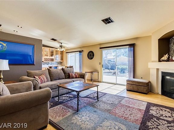 Great room with laminate floors & fireplace.