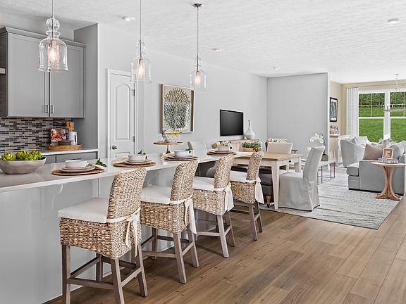 Island kitchen with gray cabinets in a DRB Homes Starling Model Home in the Grandview Estates Commun