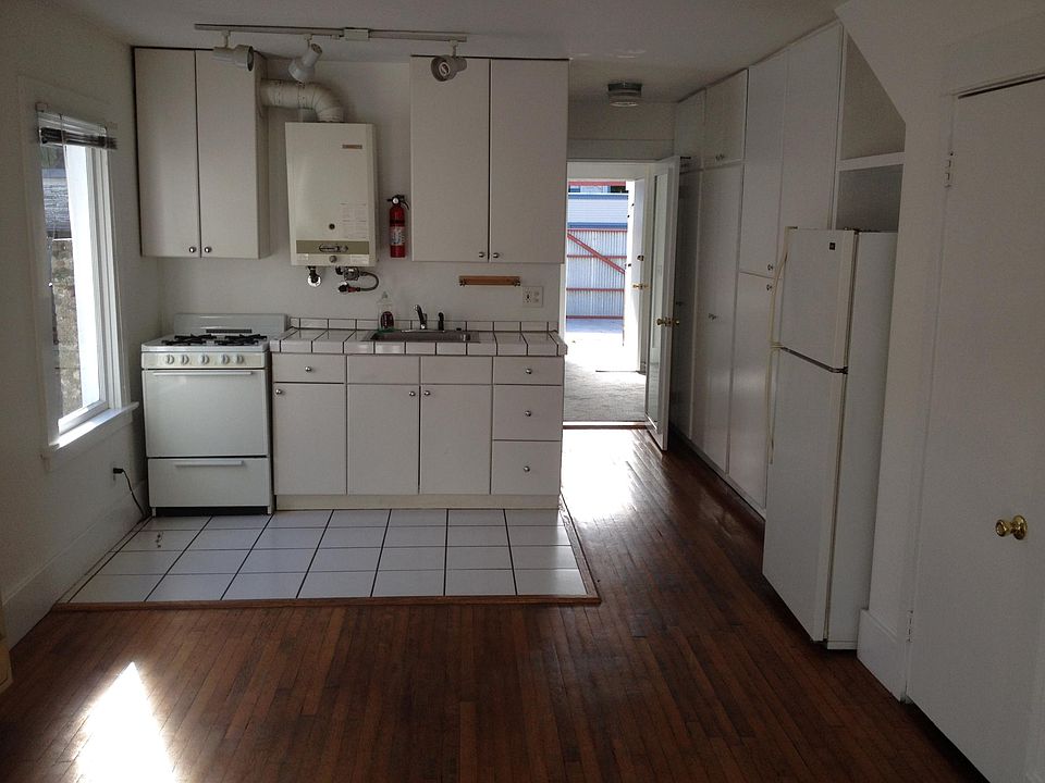 Kitchen leads to bedroom then to back area