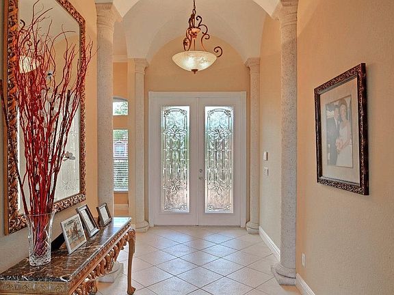 CUSTOM FRONT DOORS AND SPACIOUS ENTRY...WHAT A WELCOMING SIGHT.