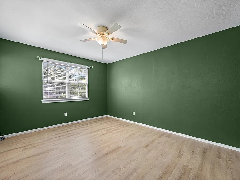 Primary bedroom upstairs with lots of natural light and two walk-in closets for ample storage.