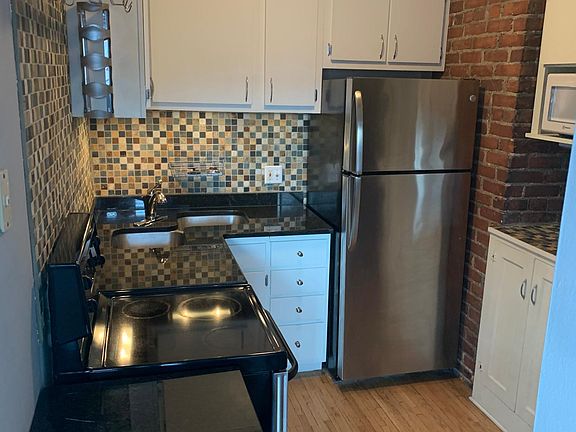 Granite countertops, exposed brick