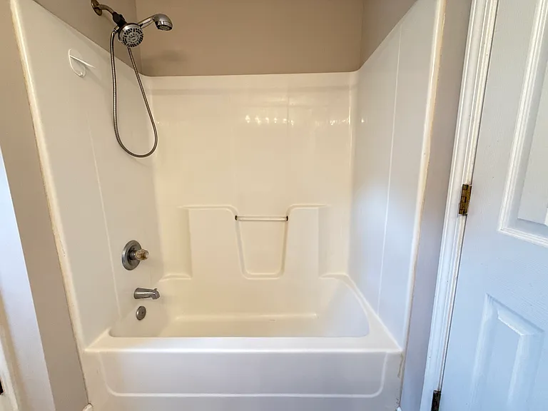 Sparkling clean shower and bathtub combination in the private master bath suite.