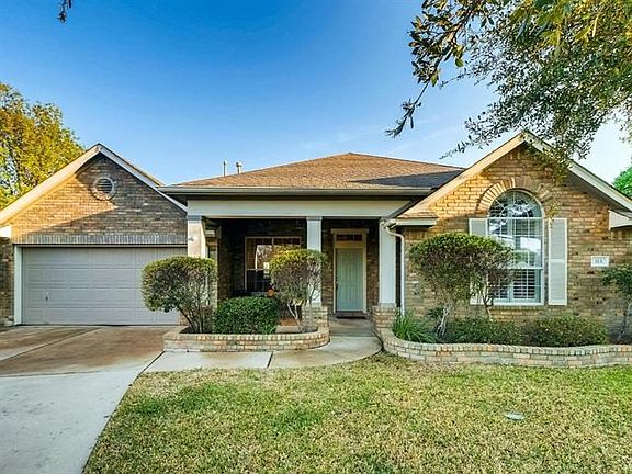 This elevation w its white shutters, white columns, arched windows and an inviting front porch says Welcome Everyone.