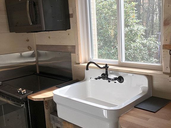 Farm sink, electric stove, microwave, butcher block counter tops.