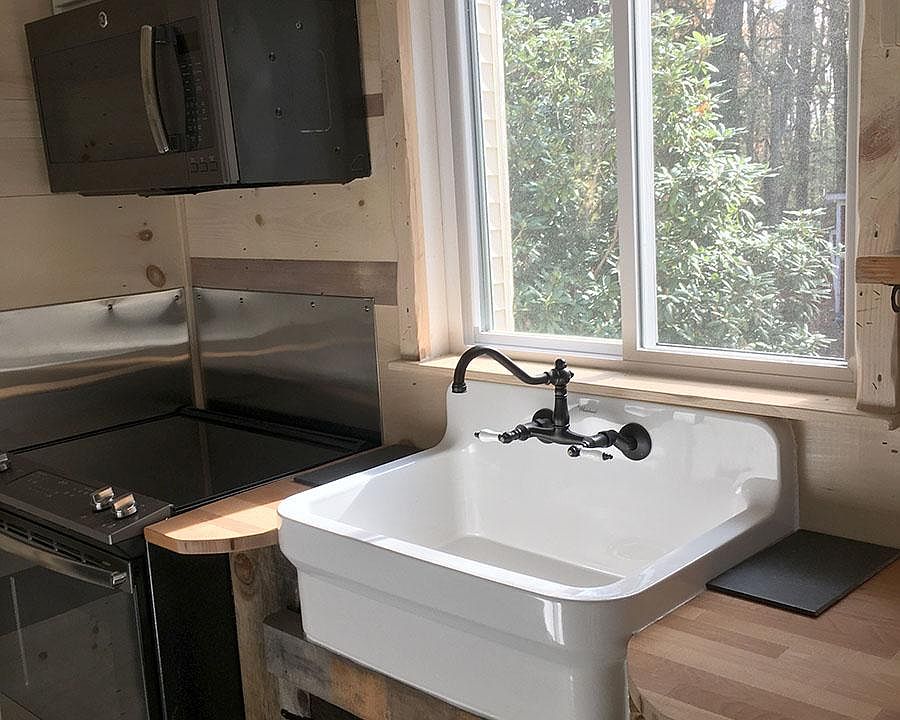 Farm sink, electric stove, microwave, butcher block counter tops.