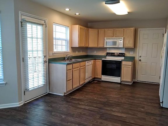 The kitchen is roomy and opens onto a back deck.