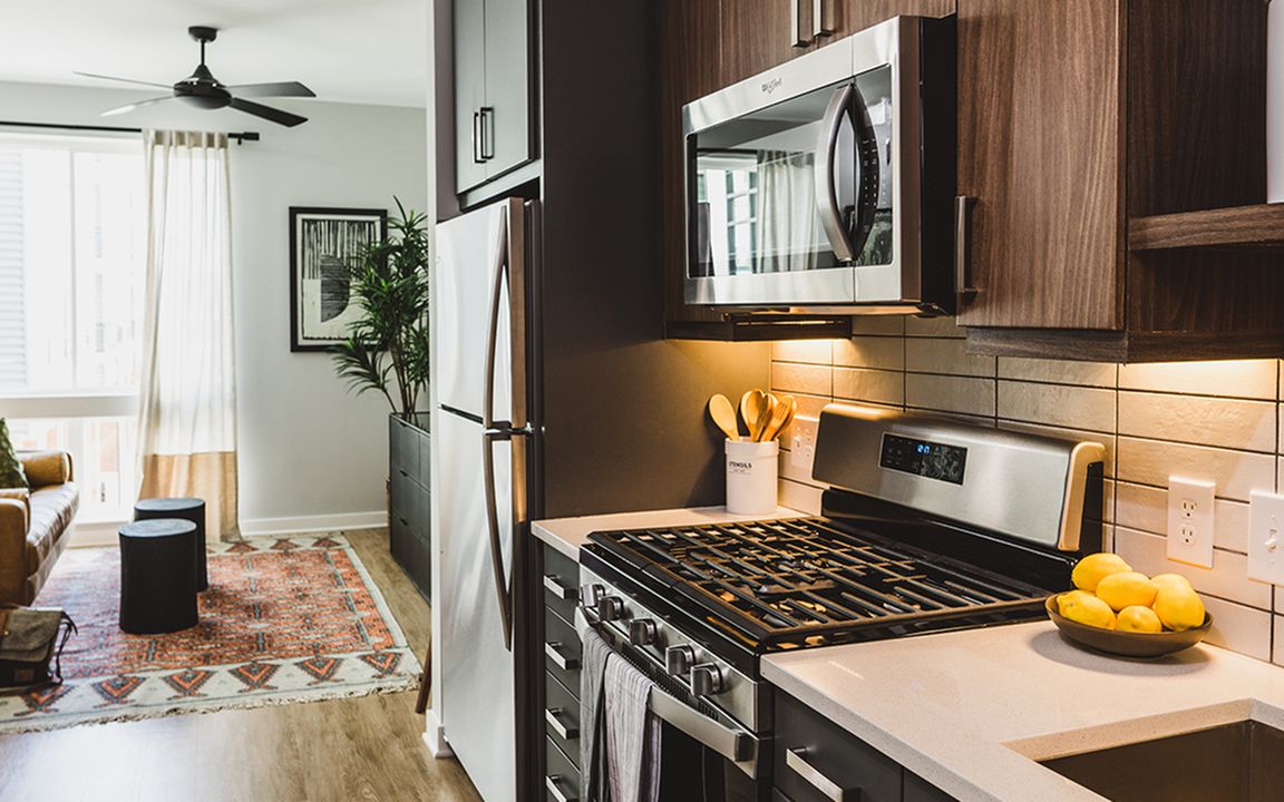 Chef-inspired galley kitchens with gas cooking, quartz counters and tile backsplash