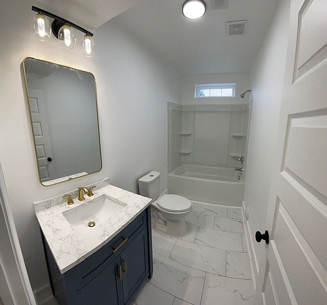 Renovated bathroom with tile floor, new vanity and modern lighting fixtures.