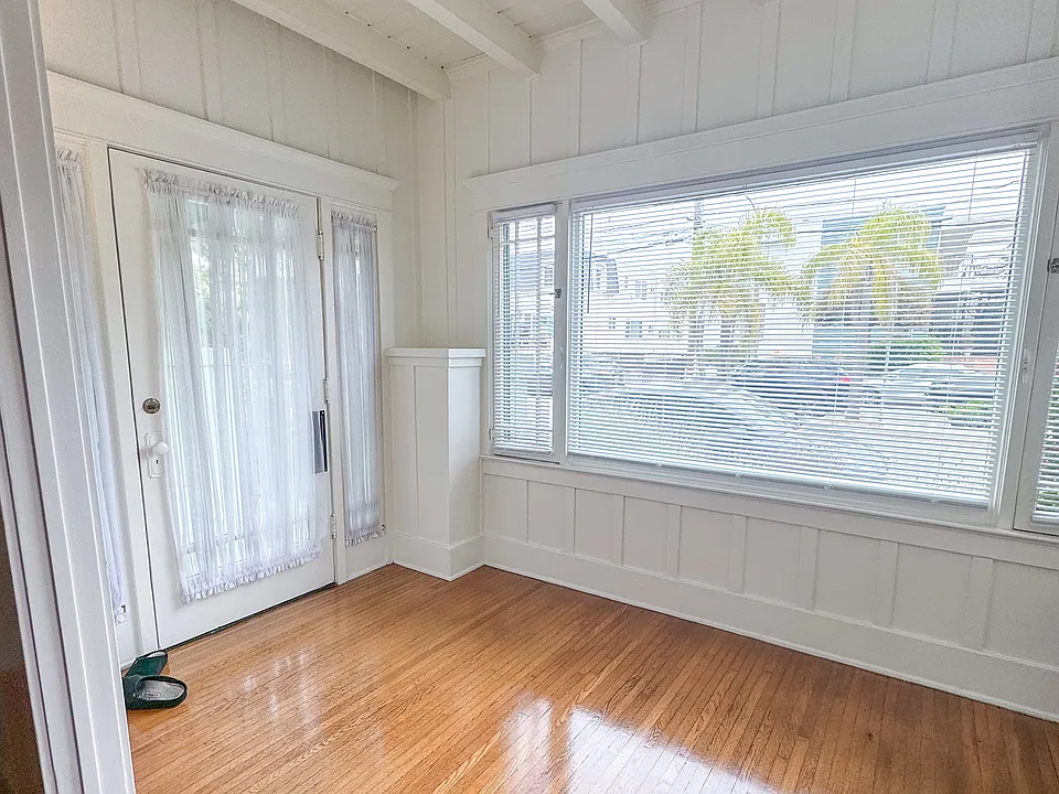 View toward front door with morning light from the East.

Original hardwood floors throughout.