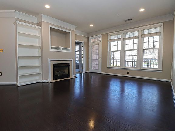 Open floor plan, high ceilings, recessed lighting, built-in bookshelf