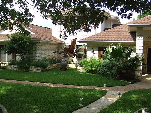 area between large oak shade trees out front