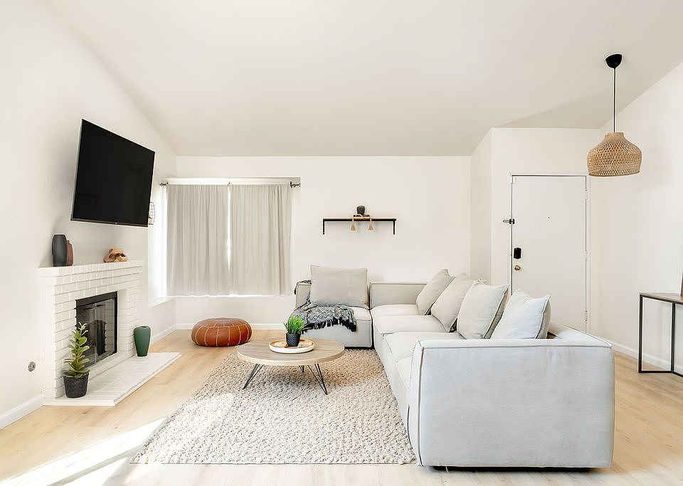 Open-concept living area with neutral decor and plenty of natural light designed for comfort during extended stays.
