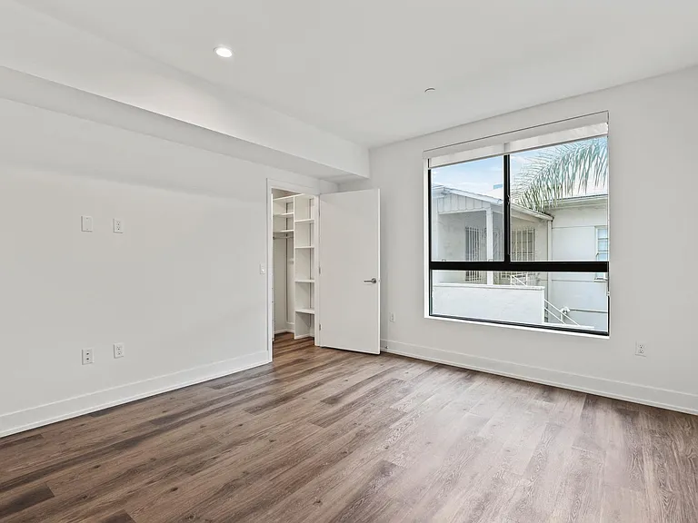 Bedroom with Vinyl Flooring and Large Windows