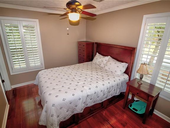 Bedroom one has a large custom closet, hardwood floors and private bath.