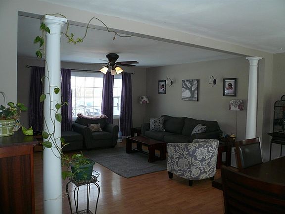 Seller remodeled into a very open concept w/decorative columns. This is the view from the kitchen.